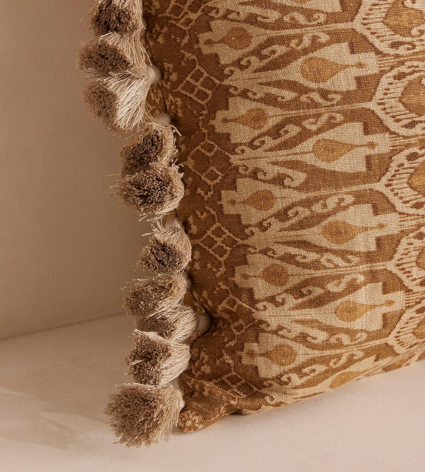 Tan Patterned Pillow With Tassel Trim