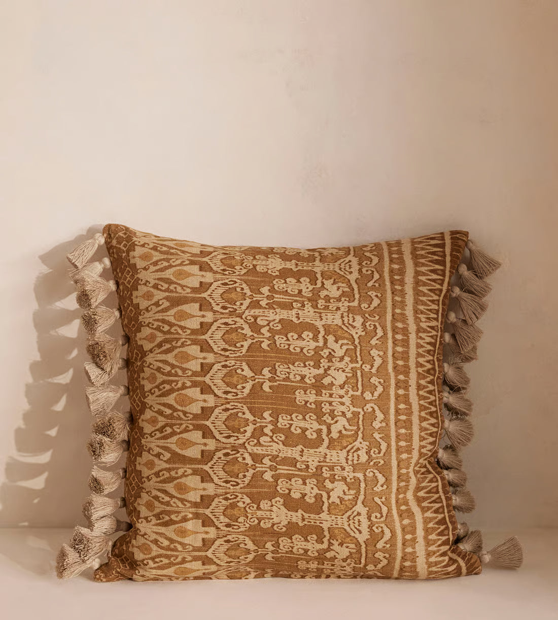 Tan Patterned Pillow With Tassel Trim