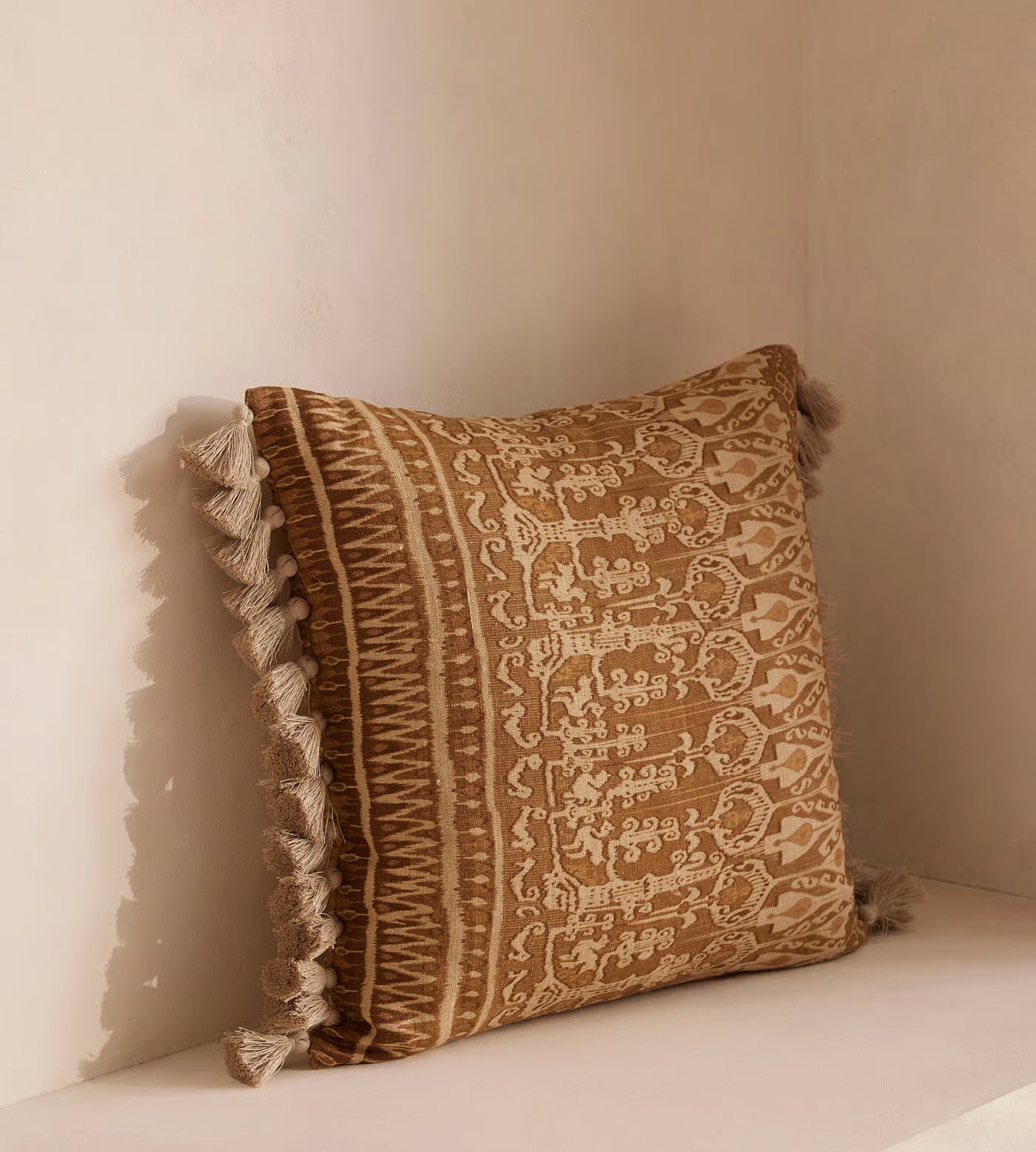 Tan Patterned Pillow With Tassel Trim