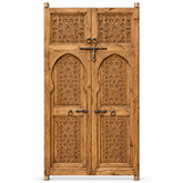 Natural wood Moroccan double door with geometric carving, horseshoe arches, and forged iron hardware