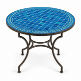 Round zellige mosaic dining table with vivid cobalt blue basketweave tile top and dark wrought iron curved base