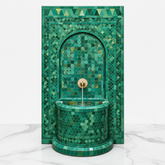 Emerald green Moroccan mosaic fountain on white marble - clean studio product shot