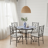 Sky blue and white pinwheel zellige mosaic dining table in a bright airy Hamptons coastal interior with white shiplap walls linen curtains pale oak herringbone floor rattan pendant and eucalyptus stems