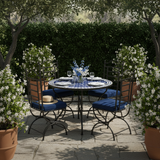 Zellige mosaic dining table in a lush garden setting with jasmine and white linen tableware