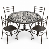 Black and white zellige mosaic dining table set with four black iron chairs, white background