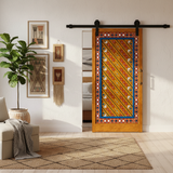 Hand-painted Moroccan sliding barn door installed in a bright upscale bohemian interior
