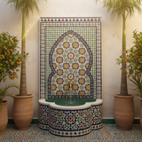 Moroccan zellige mosaic fountain mounted in whitewashed Fez riad courtyard with water flowing