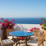 Cobalt blue zellige mosaic dining table on a sunlit rooftop terrace with bougainvillea and sea view