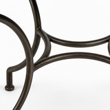 Hand-forged dark wrought iron table base with curved scrolled legs and central ring brace detail
