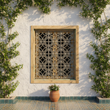 Antique Moroccan cedar window set into stone riad wall viewed from outside