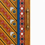 Close-up of brass-tone pull, painted motifs, and solid redwood frame