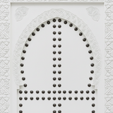 Close-up of hand-carved geometric detail and metal studs