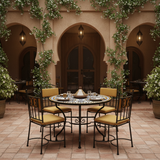 Cobalt blue and honey gold zellige mosaic table in a warm Andalusian courtyard with amber chairs and lanterns