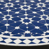 Close-up of sapphire blue and white geometric star zellige mosaic tile pattern