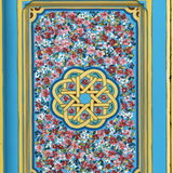 Close-up of hand-painted flowers and gold geometric medallion on blue Moroccan door