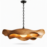 Close-up of the sculptural wooden pendant light showing its natural grain and flowing curves