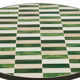 Close-up detail of hand-cut zellige tiles in green and cream mosaic pattern
