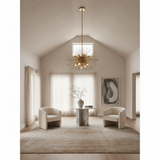 Polished brass starburst chandelier in a contemporary living room or entryway