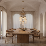 Cascading ribbed glass chandelier above a Mediterranean dining room table