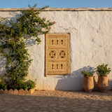 Berber wooden window set into Atlas mountain village wall exterior view