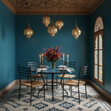 Turquoise and blue zellige mosaic dining table in a Moroccan-inspired interior dining room with teal walls carved cedar ceiling and brass pendant lights